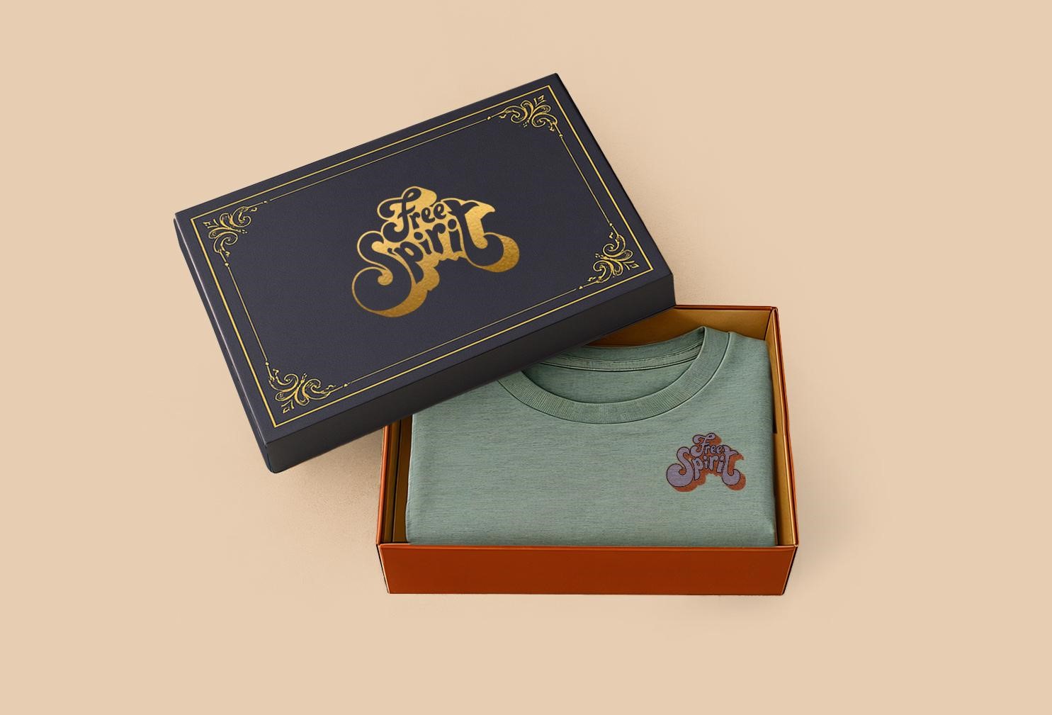 Printed t-shirt placed inside a luxury rigid gift box with gold foil design, showcasing upscale fashion apparel packaging
